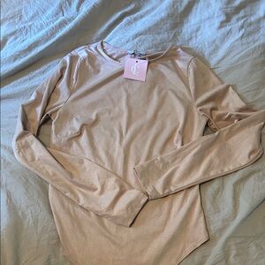Light pink. Suede material body suit. Size small. Never worn